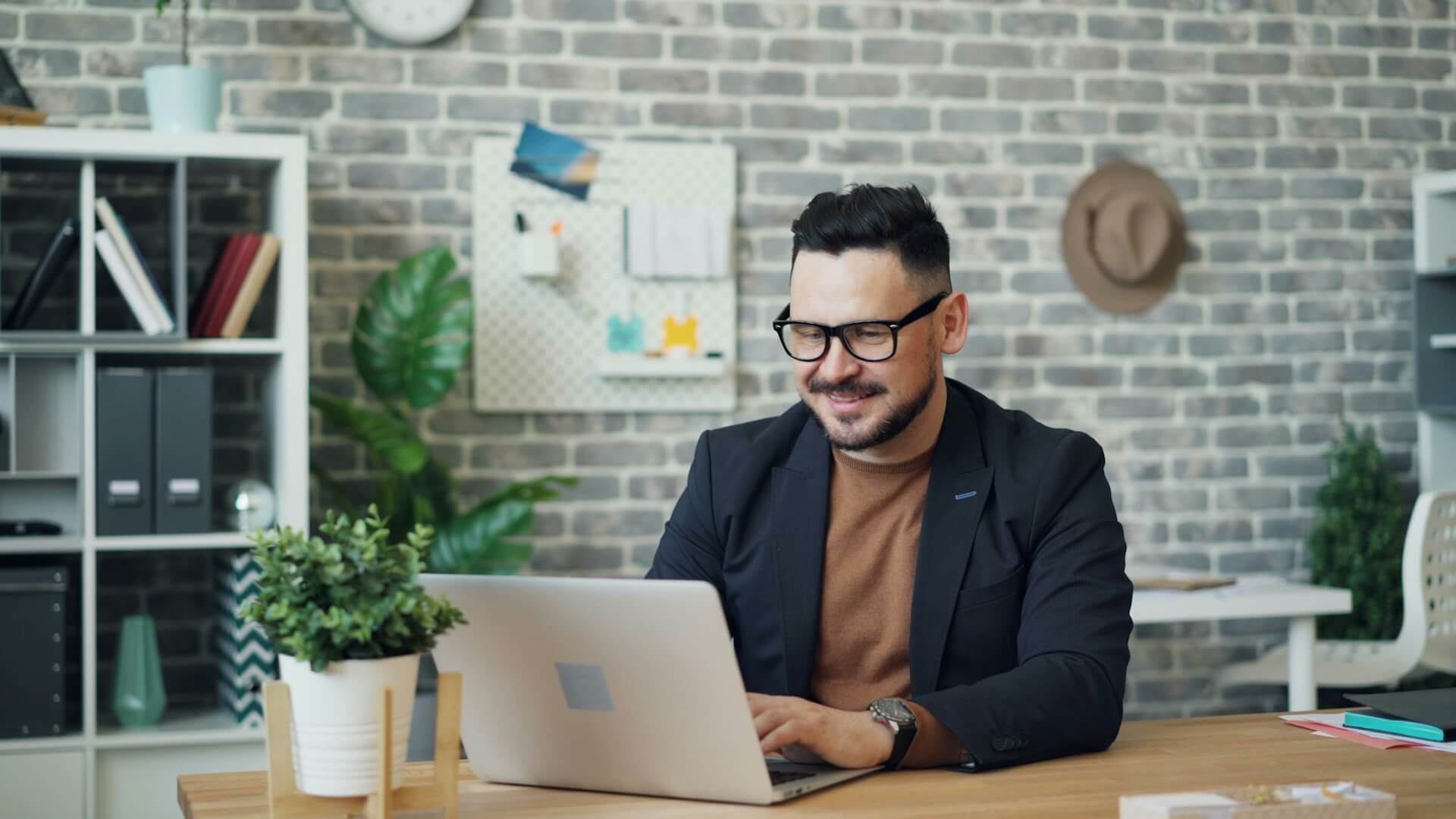 En person som sitter framför sin laptop och är glad efter rådgivning
